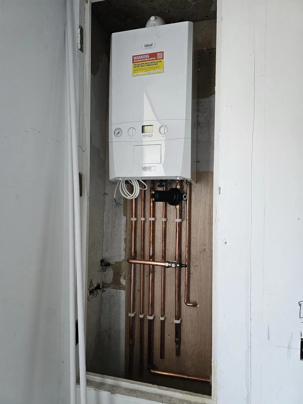 Ideal Logic combi boiler fitted by Belmont, new copper pipework run into a hallway cupboard