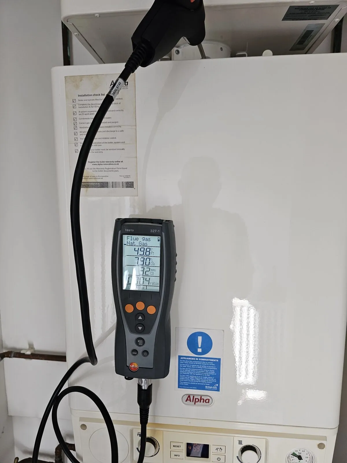 Flue gas analyser testing combustion on a gas boiler during a Belmont service visit